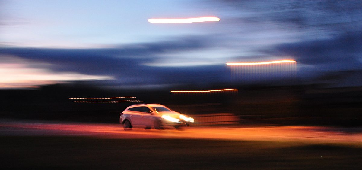 Motion blurred car on road scaled